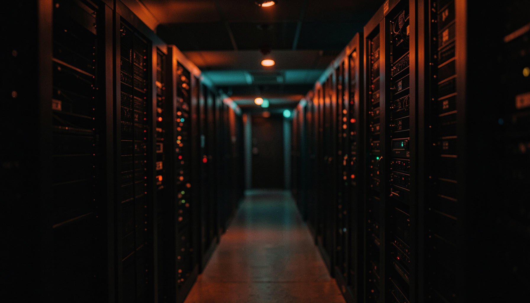 Wide cinematic view of a dark server room with subtle orange and teal accent lighting, shallow depth of field, rows of racks
